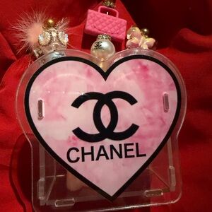 Pink Heart-Shaped Logo makeup brush holder with three makeup brushes